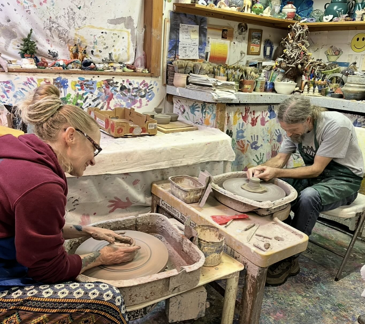 adults throwing clay